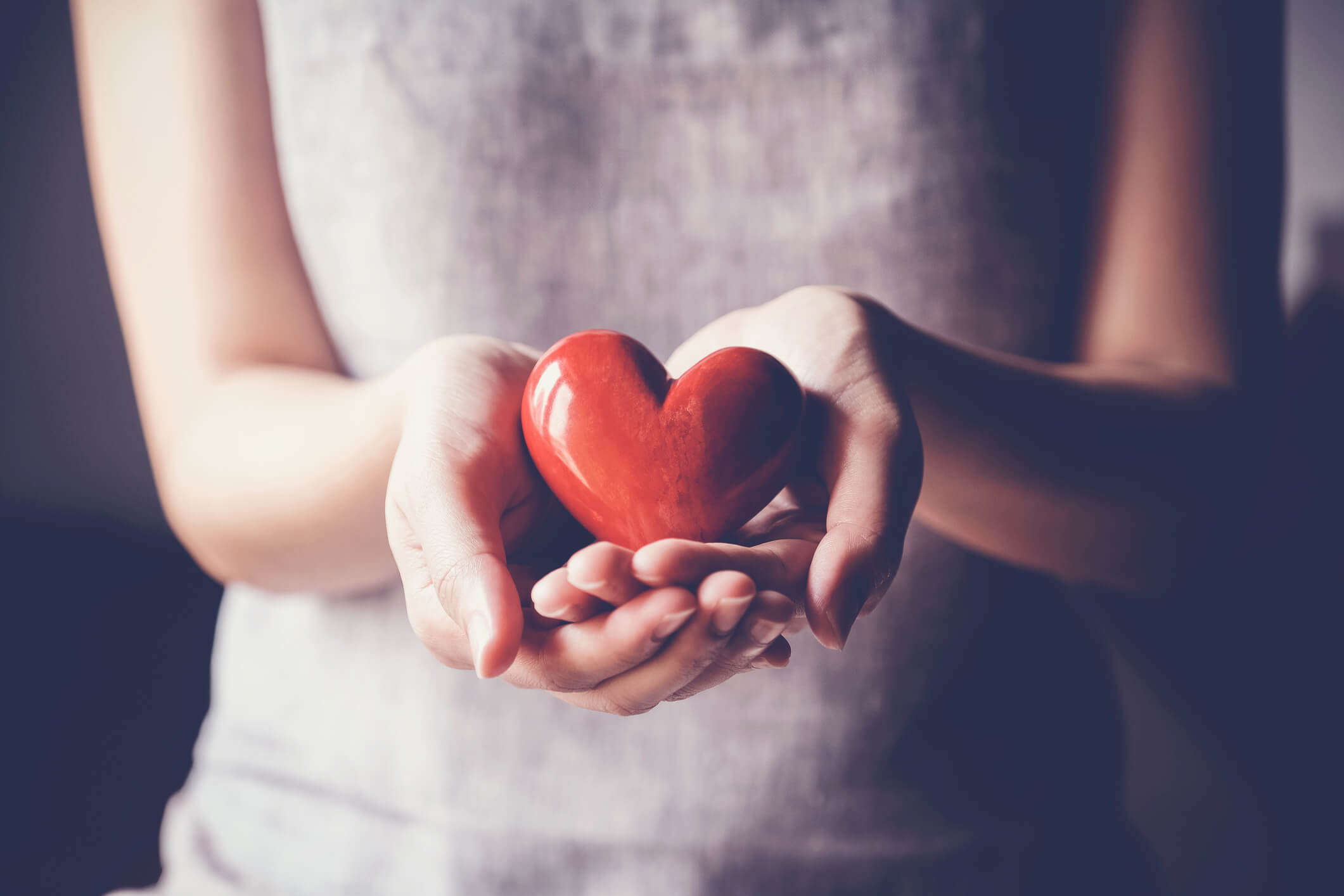 woman holding red heart